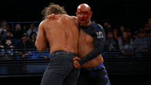 a man in a wrestling ring with a sign that says collision on it