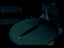 a knife is laying on a green plate