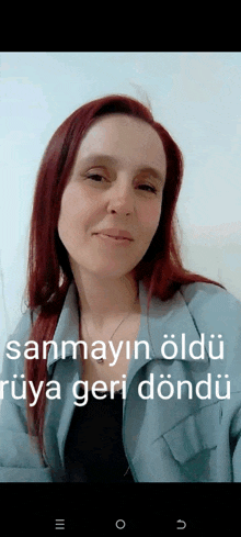 a woman with red hair is smiling with the words sanmayin oldu rüya geri döndü on the bottom