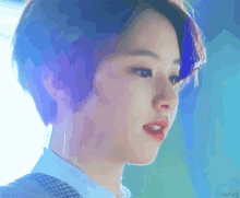 a close up of a person 's face with a blue background