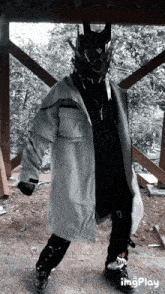 a person wearing a mask and a jacket that says ' imgplay ' on it