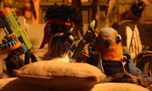two stuffed animals are sitting on a pillow and one has a nerf gun on his head