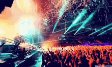 a crowd of people at a concert with confetti being thrown