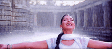 a woman with her arms outstretched in the rain