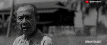 a black and white photo of an elderly man with a youtube logo in the background