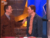 a woman is hugging a man on a television show that says hey hey saturday