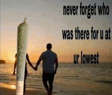 a man and a woman holding hands on the beach with a giant joint in the foreground
