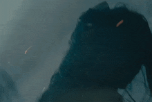 a close up of a person 's face with horns and smoke coming out of it