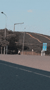 a person riding a motorcycle on a road with a sign that says ' eda akgunn '