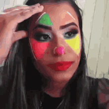 a woman with a clown face painted on her face .