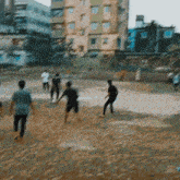 a group of people playing soccer in a field