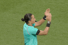 a woman wearing a watch on her wrist is pointing to her nose