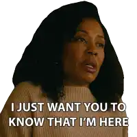 a woman in a brown sweater says i just want you to know that i 'm here