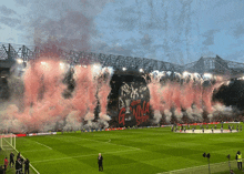 a soccer field with smoke coming out of it and a banner that says ' we 're gonna stop ' on it