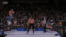 a wrestler in a ring with the aew logo on the top
