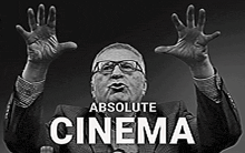 a black and white photo of a man with his hands in the air and the words absolute cinema