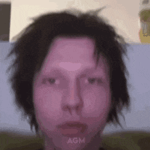 a close up of a person 's face with the letters agm visible