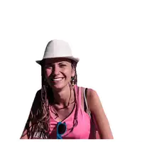 a woman wearing a pink tank top and a white hat sticks her tongue out