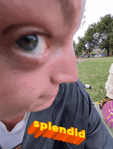 a close up of a person 's face with the word splendid written below it
