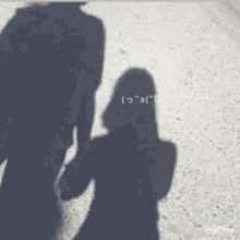 a shadow of a man and a woman on a wall with imgplay written in the corner