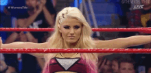 a woman in a wrestling ring with her arms outstretched .