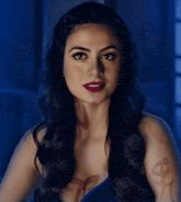a woman with long dark hair has a tattoo on her arm
