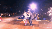 a man and a woman are dancing on a stage with a rbd.gif watermark