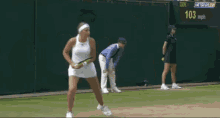 a woman in a white dress is holding a tennis racquet on a tennis court with a netspor.tv logo in the corner