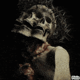 a picture of a woman with a skull and thorns on her head