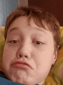 a close up of a child 's face making a funny face
