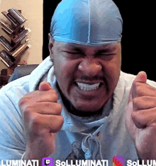 a man wearing a blue headband is giving a thumbs up sign
