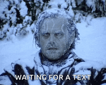 a man covered in snow with the words waiting for a text above him
