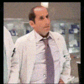 a man wearing a white lab coat and tie