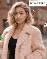a woman in a fur coat is standing in front of a diajeng logo