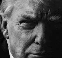 a black and white photo of a man 's face .