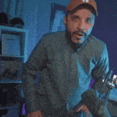 a man with a beard wearing a hat with the letter a on it