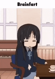 a girl in a school uniform is sitting at a table with a piano in the background .