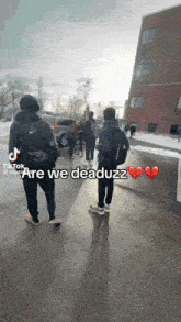 a group of people standing in front of a building with the words " are we deaduzz "