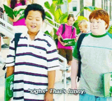 a boy says " sighs that 's funny " while holding a green book