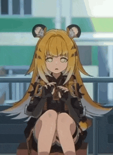 a girl with long yellow hair and ears is sitting on a bench in front of a building .