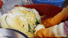 a person in orange gloves is holding a bowl of food with the words made in animotica on the bottom