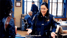 a woman in a police uniform is talking to another woman and says oh i could help you