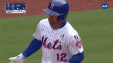 a mets baseball player wearing a white jersey with blue stripes