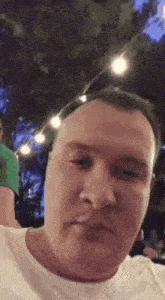 a man wearing sunglasses is making a funny face .