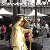 a statue of a man with the words sean wiped the team at the bottom