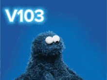 a sesame street cookie monster holding a heart with the words v103 love it above it