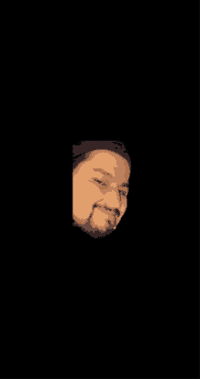 a man with a beard wearing a black hat is smiling on a black background