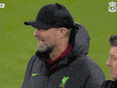 a man wearing a hat and a jacket that says lfc