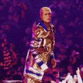 a man stands in a boxing ring with his arms outstretched in front of a sign that says wr on it