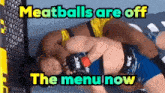 two fighters are wrestling in a ring with the words meatballs are off the menu now .